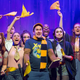 The cast of off-Broadway play, Puffs, showing their school spirit in yellow and black.